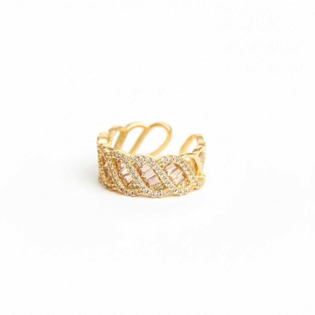 Gold ring with intricate design on a white background