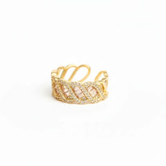 Gold ring with intricate design on a white background