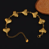 Gold bracelet with heart-shaped links on a dark background
