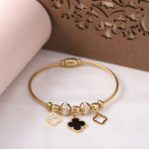 Gold bracelet with charms on a white surface