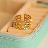 Gold leaf-patterned ring on a light green jewelry box