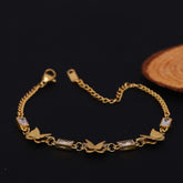 Gold bracelet with butterfly and diamond designs on a dark background