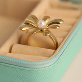 Gold ring with a pearl in a jewelry box