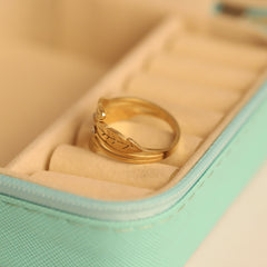 Gold ring with leaf design in a jewelry box