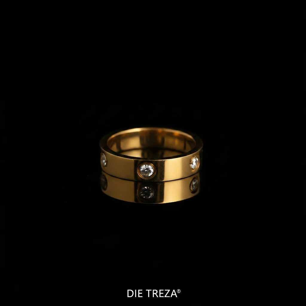 Gold ring with embedded stones on a black background, branded 'Die Treza'.
