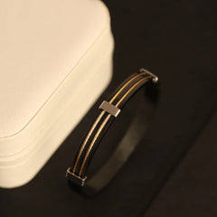 Close-up of a cap with a brown leather strap on a dark background