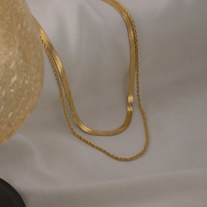 Gold chain on a light gray background